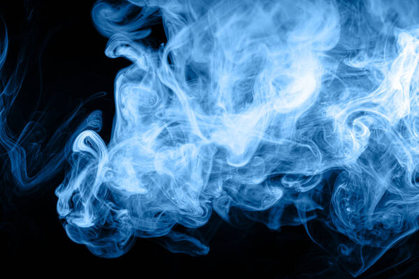 Frozen abstract movement of explosion blue smoke multiple colors on black background. Background from the smoke of vap