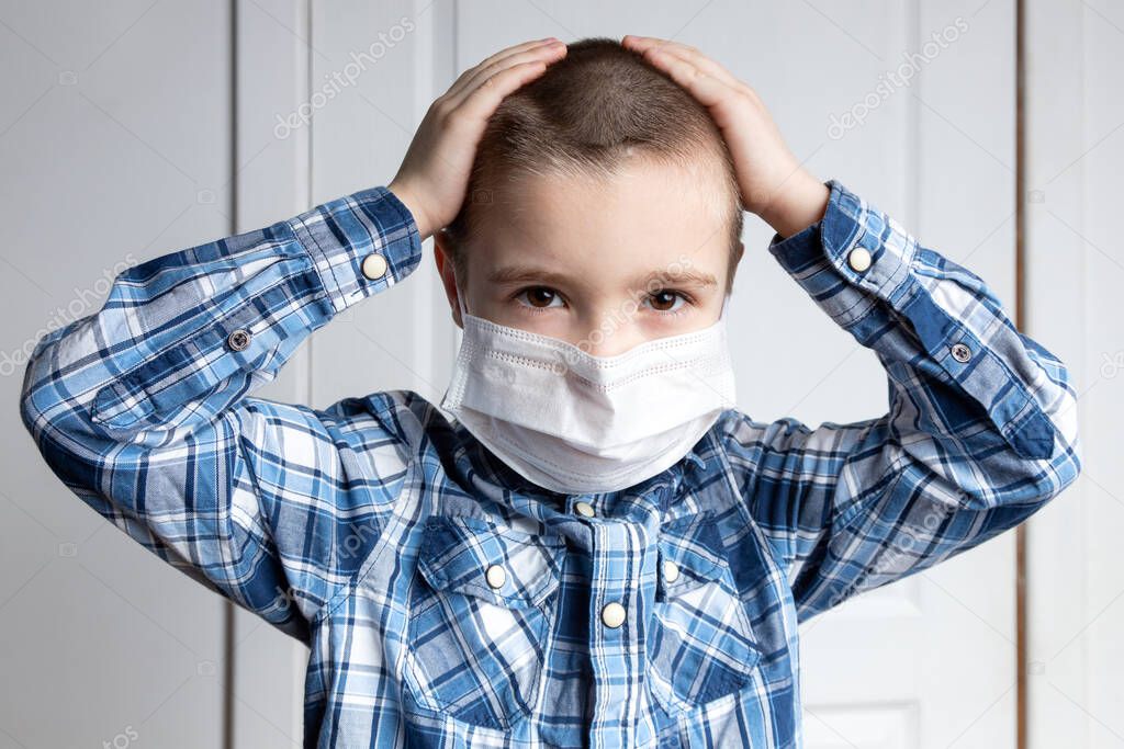 Young boy with sore eyes in a medical mask look at camera. Medical protection against airborne diseases, coronavirus. hild is afraid of getting the flu 