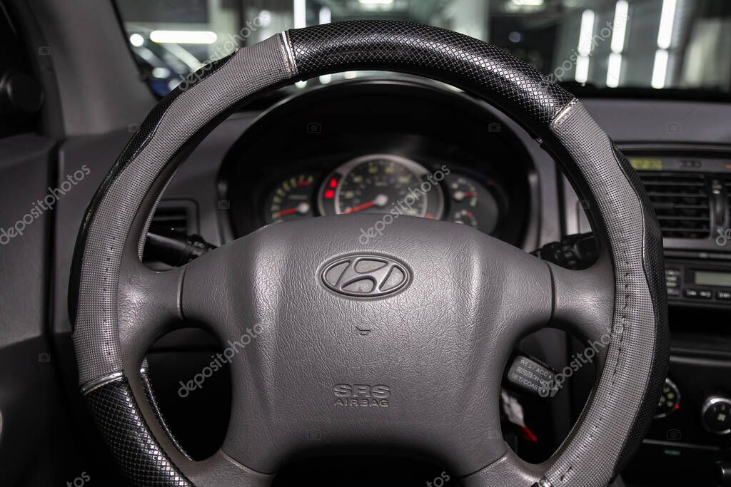 Novosibirsk, Russia  February 10, 2020:   Tucson Hyundai,  Auto interior: steering wheel with red logo  Tucson  and  speedometer and tachometer