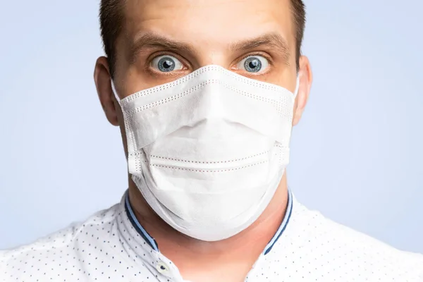 Young man wear masks to prevent air pollution, haze and PM 2.5 dust and smoke pollution on white background. Medical protection against airborne diseases, coronavirus. Man is afraid of getting the flu