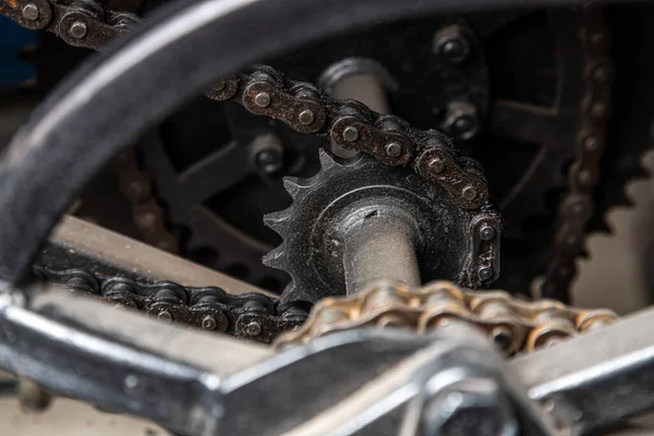 Close-up device of a complex transport mechanism. Suspension of a bicycle, car. Set of various spare parts for car chassis. Metal machinery background. wheel engine gears, close-up
