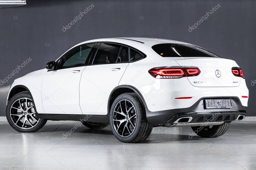 Novosibirsk/ Russia  April 11 2020: white Mercedes-Benz GLC-class 300,  mid-range city SUV, back view. New   expensive  car  on dark background