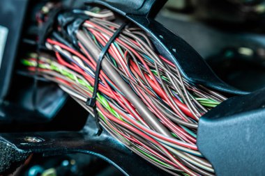 Close up of the engine control unit of the car, multicolored wires plug  - a wiring of a truck car clipart