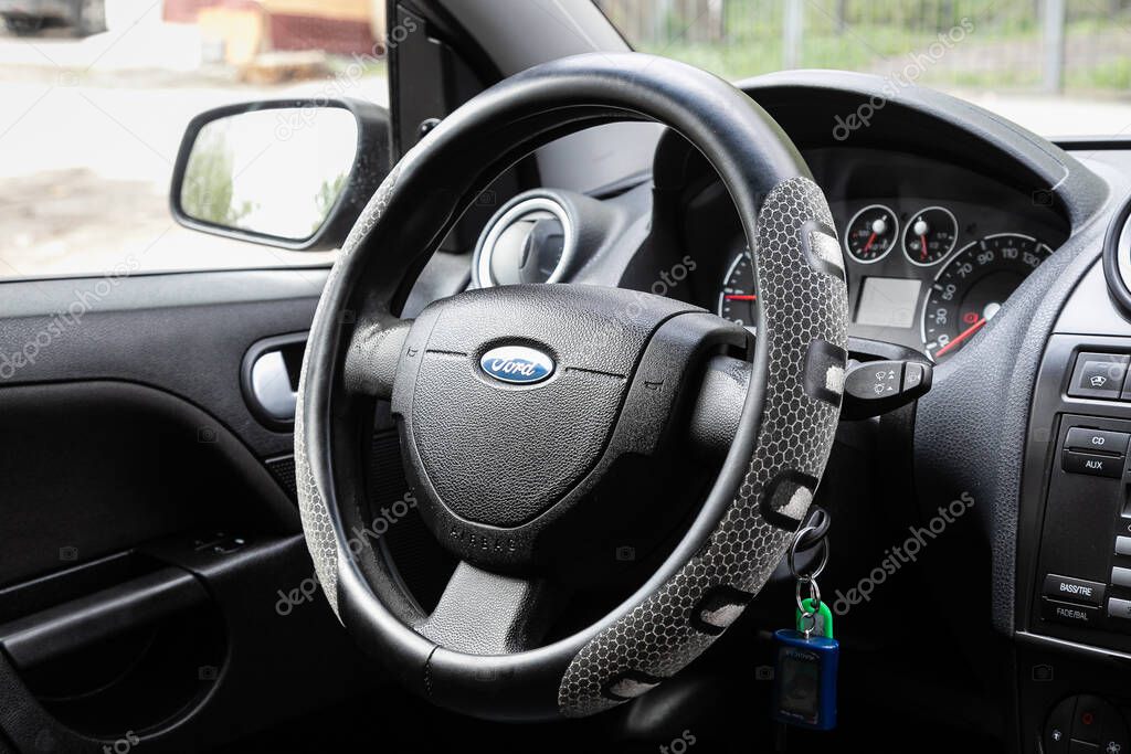Novosibirsk/ Russia  May 02 2020: Ford Fiesta, Auto interior: steering wheel with red logo  Mitsubishi  and  speedometer and tachometer