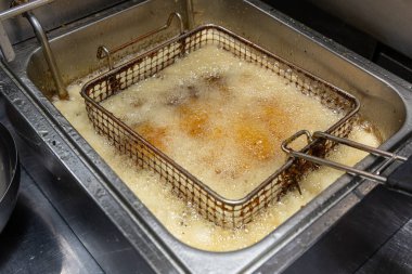 Yakın plan büyük et parçaları profesyonel bir mutfakta büyük miktarda kızgın metal ile kızartılır. Kızarmış et süreci.