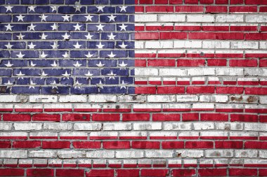 Ulusal Amerikan bayrağı eski bir tuğla duvarda boya renkleriyle tasvir ediliyor. Tuğla duvar arka planında bayrak pankartı.