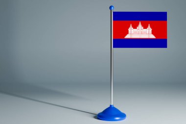Kamboçya 'nın 3D gerçekçi ulusal bayrağını izole edilmiş gri arka planda çelik direğe asıyor. Boş masa bayrağı, tasarım için uygun, alaycı