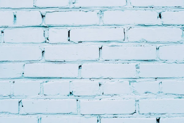 Blue cracked brick wall