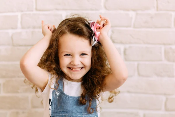 Little girl putting up her hands to depict horns — Stock Photo, Image