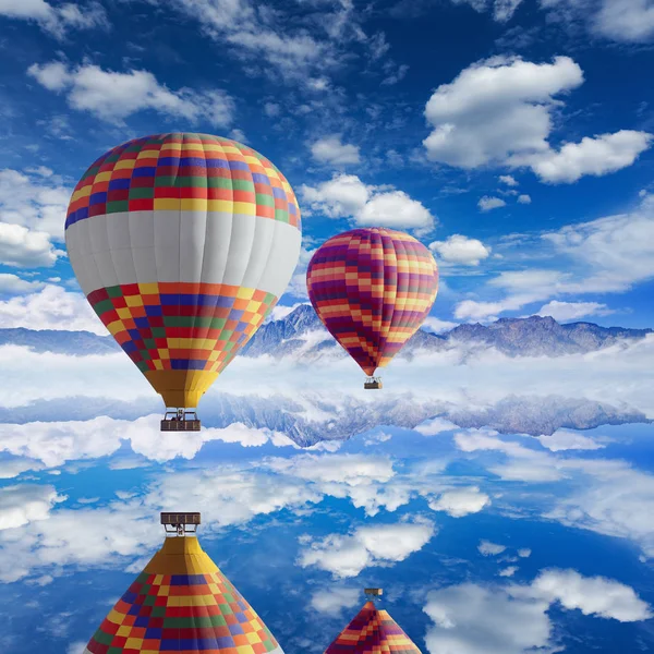 Colorful hot air balloons flies above calm lake — Stock Photo, Image