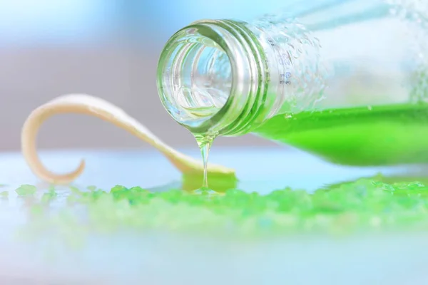 Glass bottle and green juice inside