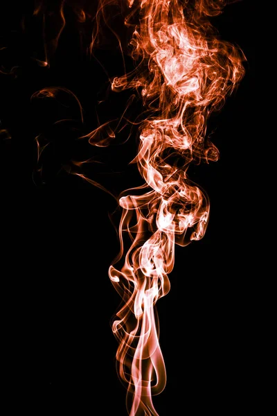 Abstrakta färg rök på svart bakgrund, orange rök bakgrund, orange bläck bakgrund, orange rök, Orange rök abstrakt tapet eller bakgrunden, eld och rök isolerade på svart Royaltyfria Stockfoton