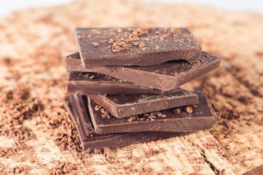 Ahşap masa üzerinde koyu çikolata. Çikolata kırıntı