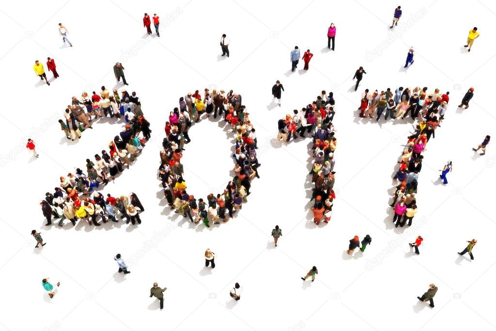 Bringing in the new year. Large group of people in the shape of 2017 celebrating a new year concept on a white background