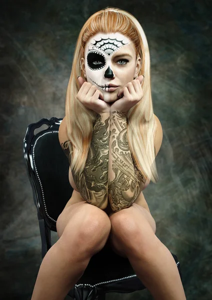 Front portrait of a sitting semi nude female with skull make up and tattoos . 3d rendering