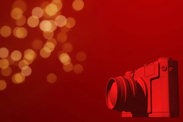 red camera on red background, with golden sparkles