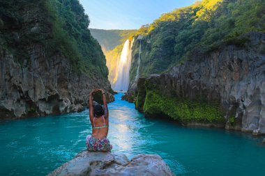 TAMUL, SAN LUIS POTOSI MEXICO - January 6, 2020:young women posing in River amazing crystalline blue water of Tamul waterfall