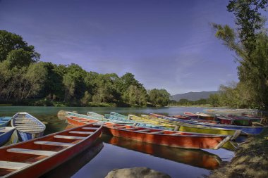 TAMUL, SAN LUIS POTOSI MEXICO - January 6, 2020:Colorful canoes on the Tamul river in Huasteca, these canoes will be used for the river tour and until you reach the waterfall