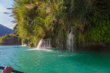 Amazing crystalline blue water of Tamul waterfall, Close up view of spectacular Tamul River,at Huasteca Potosina in San Luis Potosi, Mexico