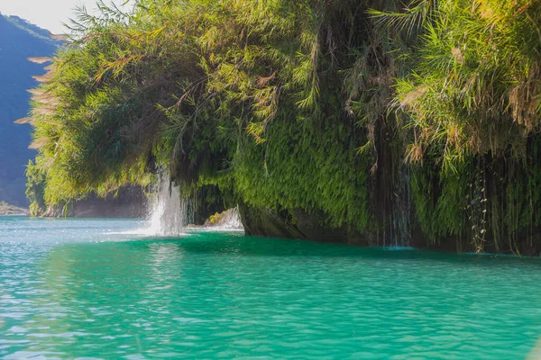 Amazing crystalline blue water of Tamul waterfall, Close up view of spectacular Tamul River,at Huasteca Potosina in San Luis Potosi, Mexico