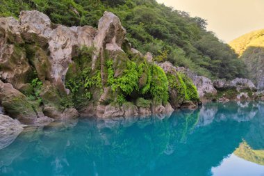 Amazing crystalline blue water of Tamul waterfall, Close up view of spectacular Tamul River,at Huasteca Potosina in San Luis Potosi, Mexico