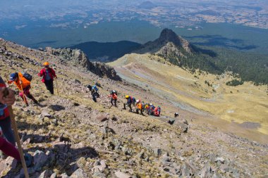 Tlaxcala, Puebla, Mexico, March 2, 2020: group of mountaineers ascending to the chasm of the malinche volcano clipart