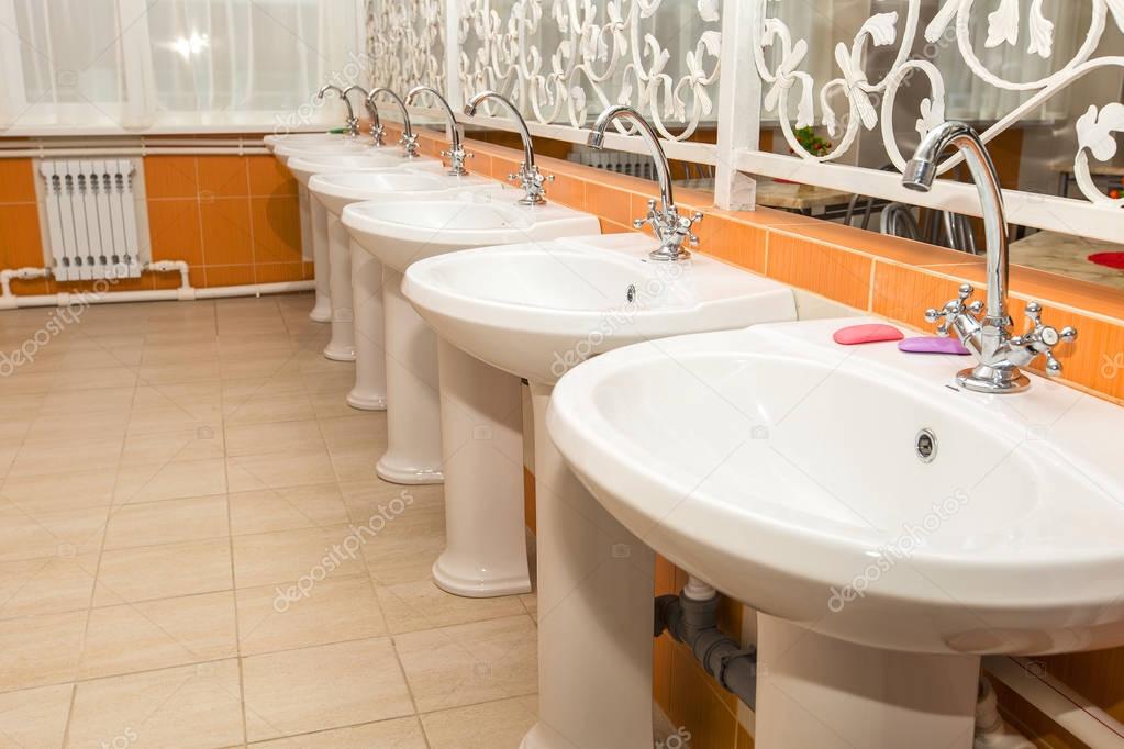 New white ceramic sinks and hand dryers