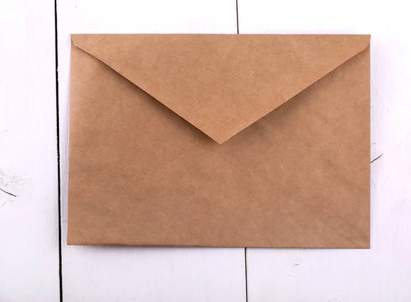 Paper envelope on a white wooden table. — Stock Photo, Image