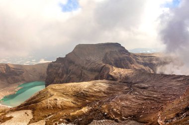 Green lake in the mouth of Gorely volcano  clipart