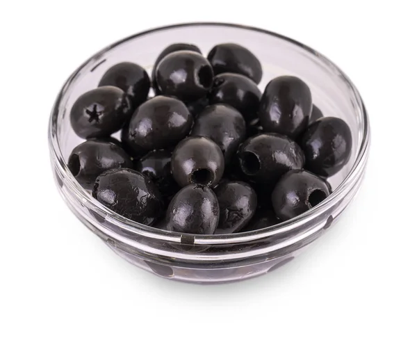 Чорні оливки без ям лежать у склянці на білій спині — стокове фото
