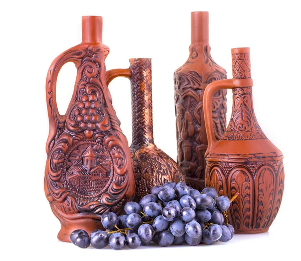 Clay bottles and grapes on a white background. — Stock Photo, Image