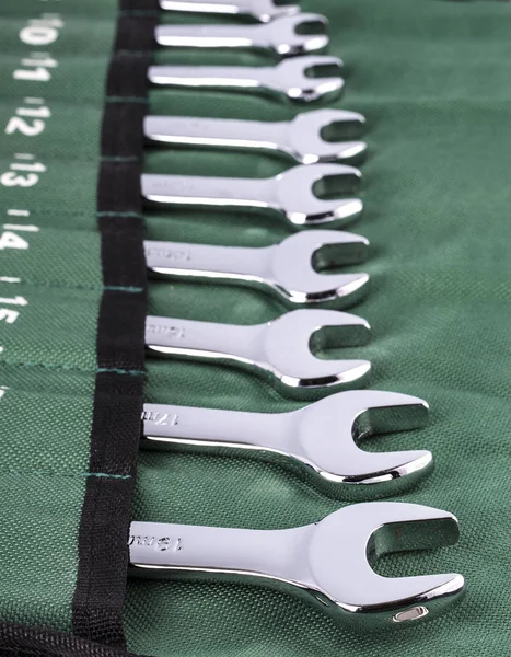 Open-end wrench set on green cover.