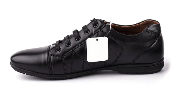 Czarny skórzany but z etykietą na białym — Zdjęcie stockowe