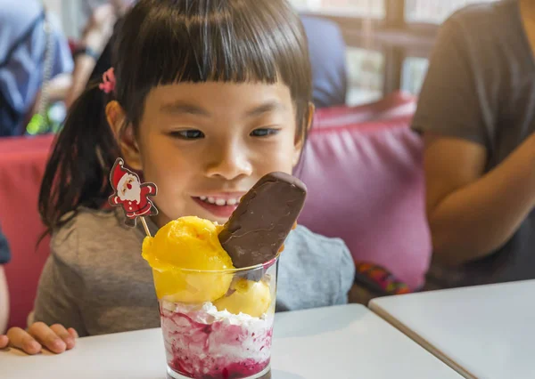 Girl happy with ice cream. Focus on ice cream