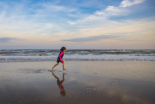 Little motion blurred image. Little girl running on beach. — Stock Photo, Image