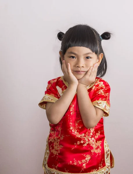 Adorable little girl in red Chinese dress — Stock Photo, Image