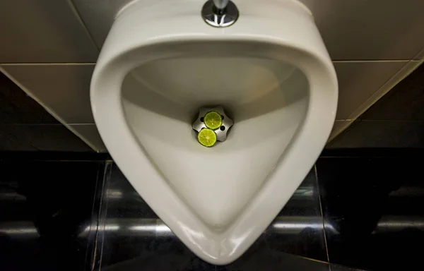 Sliced Bergamot in urinal — Stock Photo, Image