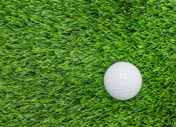 Golf ball on green grass.