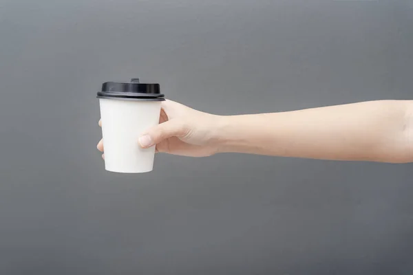 Take away coffee cup background. Female hand holding a coffee pa