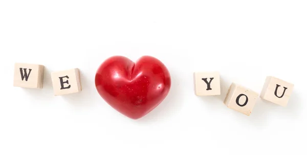 Red heart and wooden cubes with We and You, on white background. We love you concept. — Stock Photo, Image