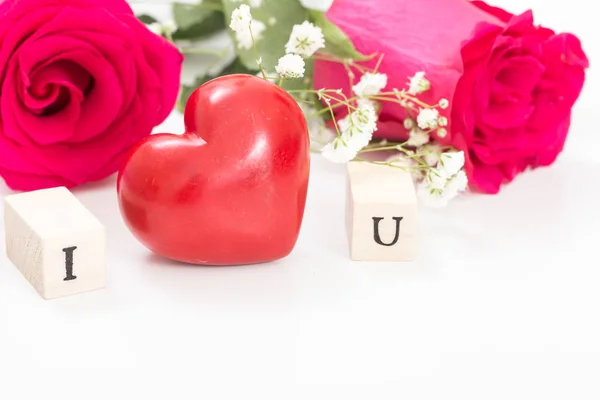 Coração vermelho e rosas, e cubos de madeira com letras I e U, sobre fundo branco. Eu te amo conceito . — Fotografia de Stock