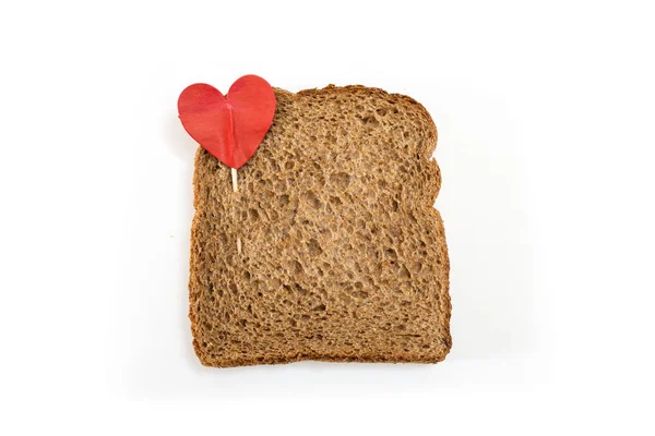 Whole grain sandwich bread slice with heart pin, on white background. — Stock Photo, Image