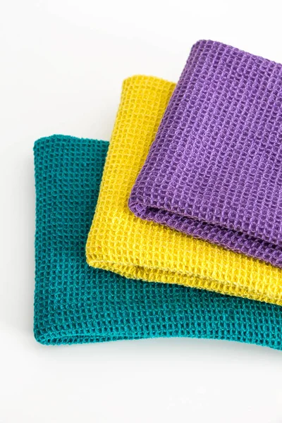 Stack of folded colorful kitchen towels, on white closeup background. — Stock Photo, Image