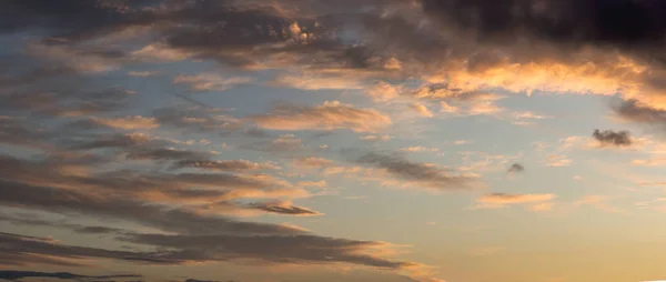 Goldener Morgen- / Abendhimmel, mit dunklen Wolken im Hintergrund. — Stockfoto