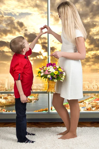 Woman and child with bouquet of flowers. Spring family holiday concept. Women\'s day.