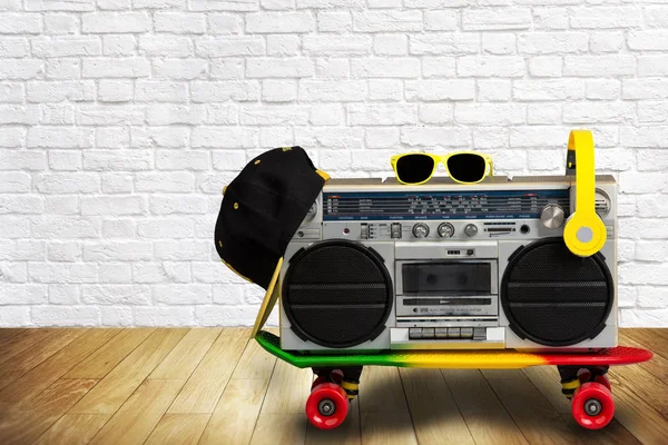 The concept of the music Hip hop style.Vintage audio player with headphones.Skateboard ,fashionable cap and sunglasses.isolated — Stock Photo, Image