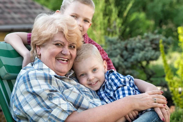 Family portrait.Beautiful grandma and her two beloved grandchildren.