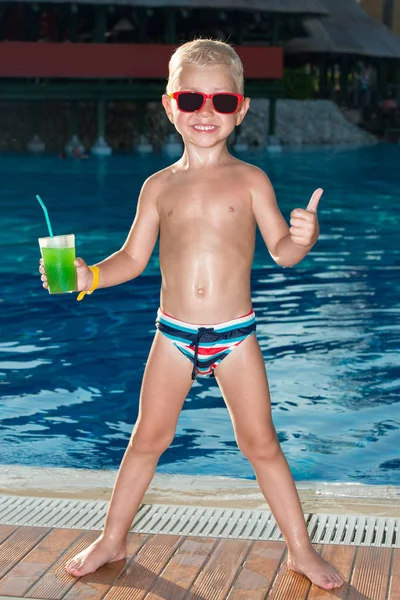 Little boy with cocktail at swimming pool on sunny day — Stock Photo, Image