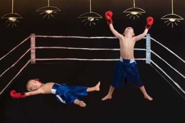 Boxing match of two brothers.Drawings in chalk on the wall.