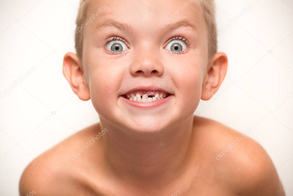  The little boy falls out a baby tooth.Child waits for the tooth fairy.